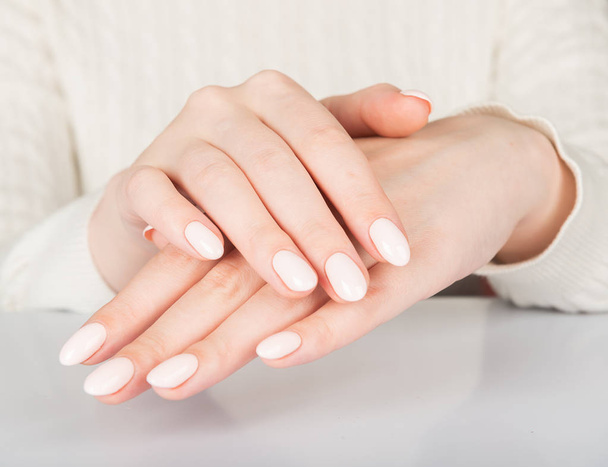 Beautiful female hand with beige nail design - Фото, изображение