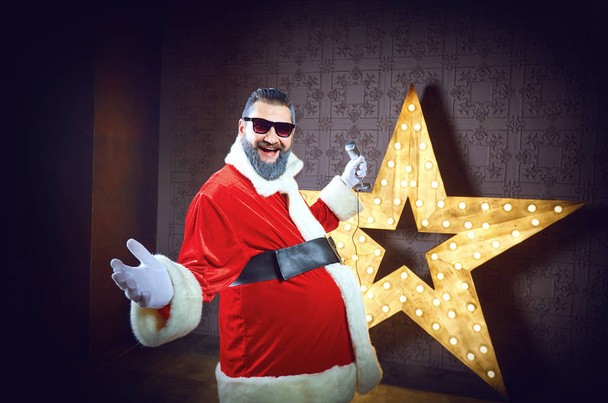 Santa Claus DJ on the background of the electric star in Christm - Photo, Image