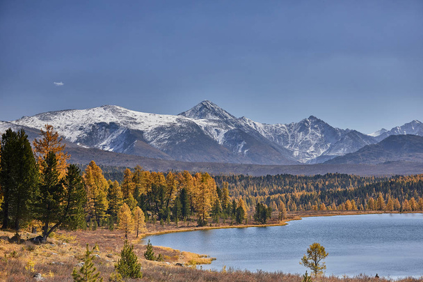 First snow on Lake. Colorful autumn landscape. - Fotó, kép