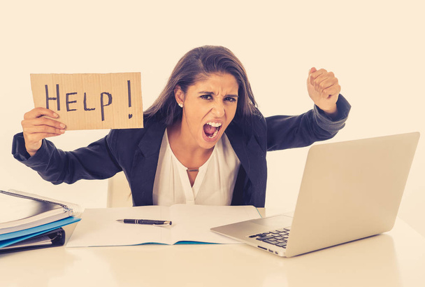 Young attractive businesswoman working on computer laptop suffering stress at office going crazy holding a help sign - Foto, Imagen