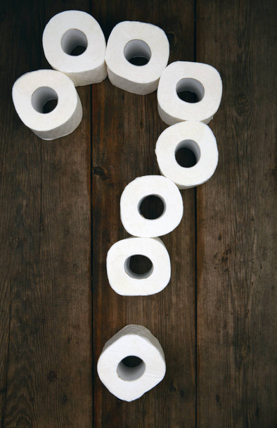 Toilet paper Question symbol wooden table - Foto, afbeelding
