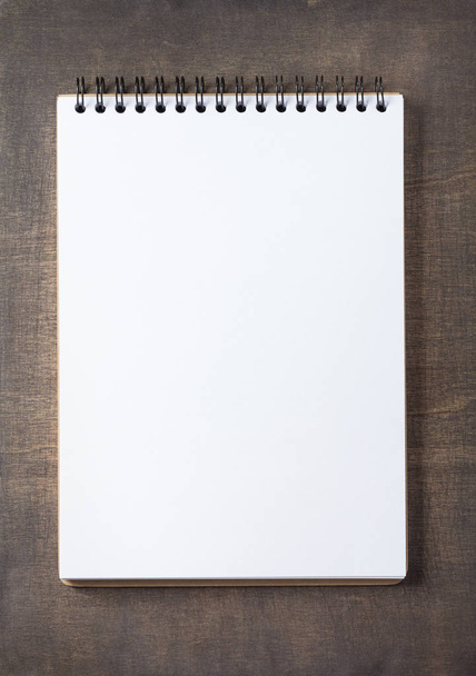 notepad at wooden background surface table, top view - Foto, immagini
