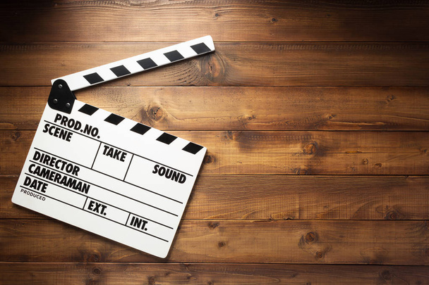 movie clapper board at wooden background texture, top view - Photo, Image