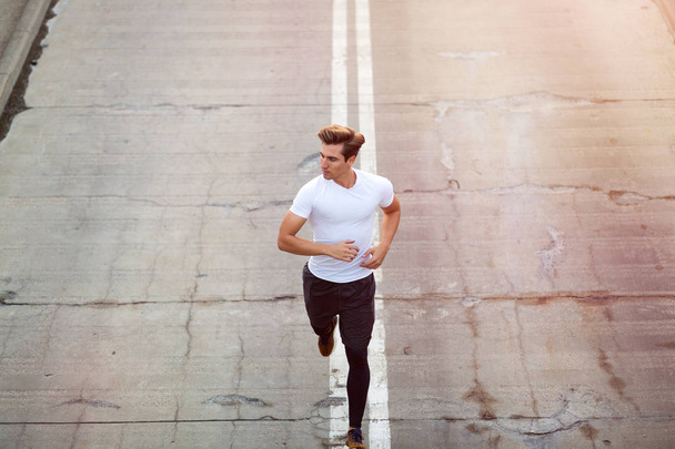 Young man running in urban area - Foto, Imagem