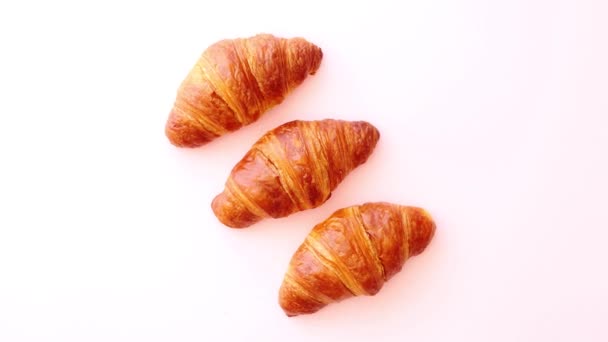 Row of three fresh and delicious croissants - Footage, Video