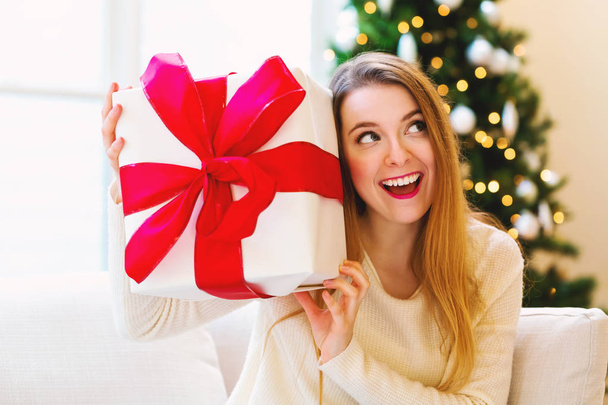Happy woman holding a big gift box - Фото, изображение