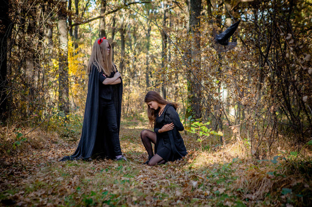 Halloween demon and witch in the woods. - Foto, afbeelding