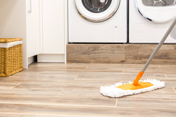 Fußbodenreinigung in der Waschküche im modernen Haus - Foto, Bild
