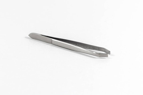 Clean shoot of metal reflective tweezers with white background - Photo, Image