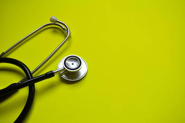 stethoscope with healthcare concept inspiration on yellow background - Photo, Image