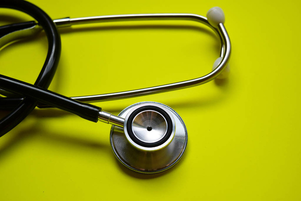 stethoscope with healthcare concept inspiration on yellow background - Photo, Image