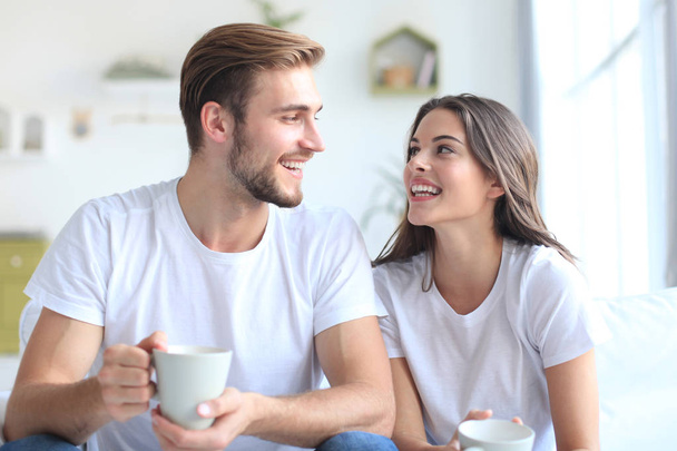 Cheerful young couple in the morning at home in the living room. - Foto, Imagem