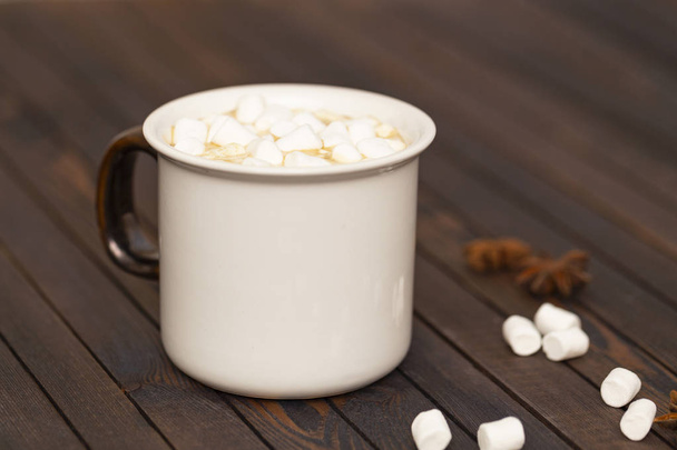 Cup of cocoa with marshmallows on wooden background - Foto, afbeelding