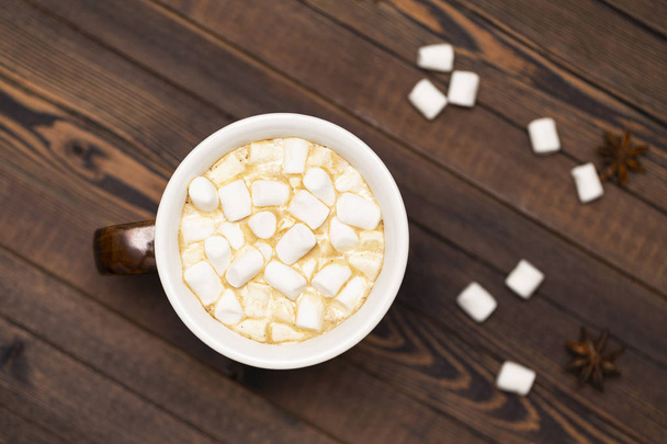 Cup of cocoa with marshmallows on wooden background, the view from the top - Фото, зображення