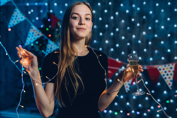 Young woman with glass of champagne. New Year, Christmas - Фото, изображение