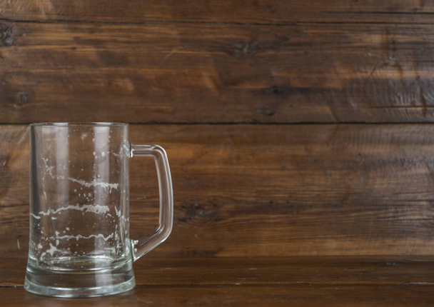 Empty beer mug, large empty pint of beer on old wooden table. - Photo, Image