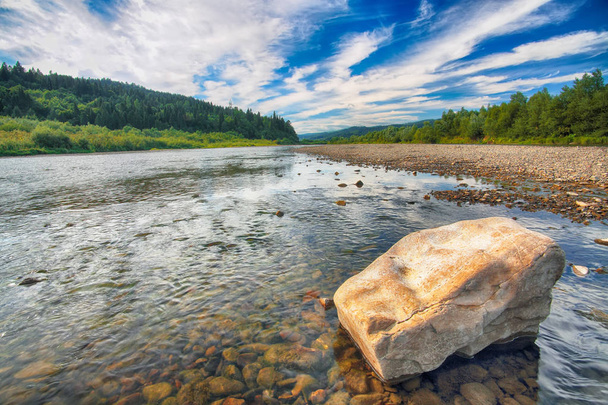 Mountain river stream of water in the rocks with majestic blue sky. Clear river with rocks. Stone foreground. Carpathian region. Ukraine - Photo, Image