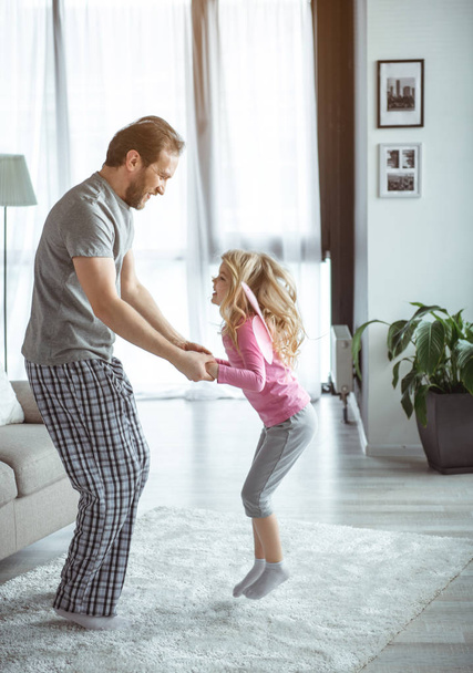 Cheerful dad and daughter having fun in house  - Foto, Imagem