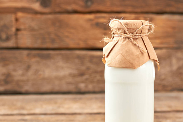 Bottle of healthy milk on wooden background. - Foto, Bild