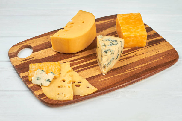 Various types of cheese on wooden board. - Photo, Image