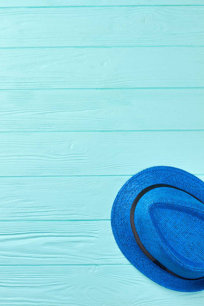 Blue woven hat with black ribbon. - Foto, imagen