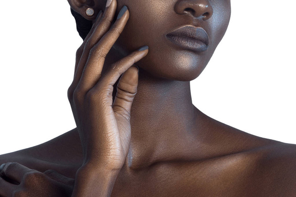 Palm and lips of young beautiful black woman with clean perfect skin close-up. Skin care and beauty concept - 写真・画像