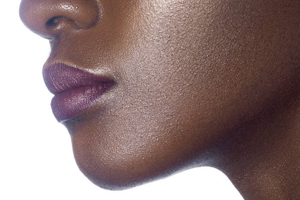 Lips of young beautiful black woman with clean perfect skin. Beauty, cosmetics and makeup - Photo, Image