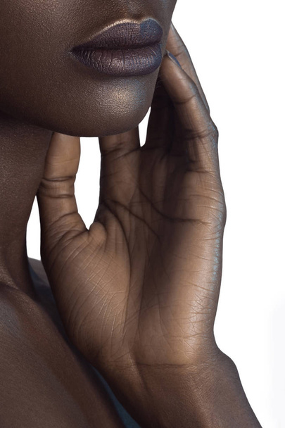 Palm and lips of young beautiful black woman with clean perfect skin close-up. Skin care and beauty concept - Foto, Imagen