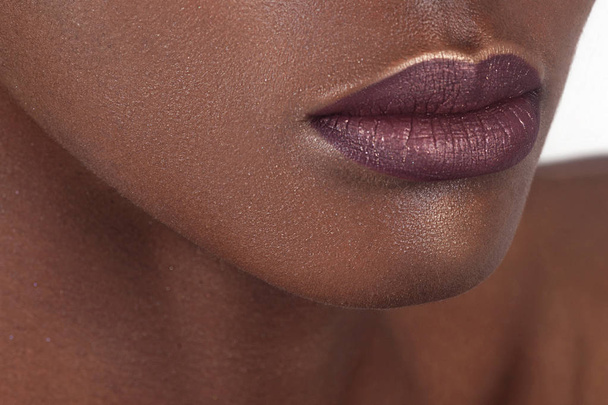 Lips of young beautiful black woman with clean perfect skin. Beauty, cosmetics and makeup - Fotografie, Obrázek