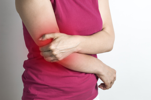 A woman has an elbow pain. - Foto, imagen
