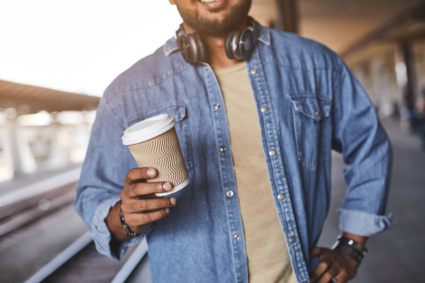 Close up of a coffee cup in hands of a pleasant man - Foto, Bild