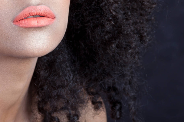 Lips of young beautiful black woman with clean perfect skin close-up. Skin care and beauty concept - Foto, imagen