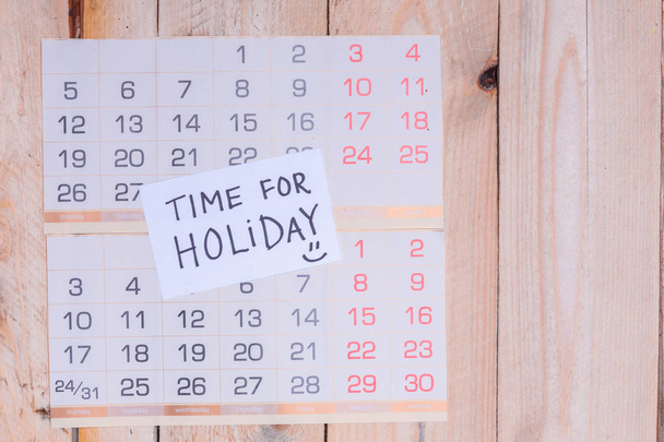 Time For Holiday written on paper note on a wall calendar - 写真・画像
