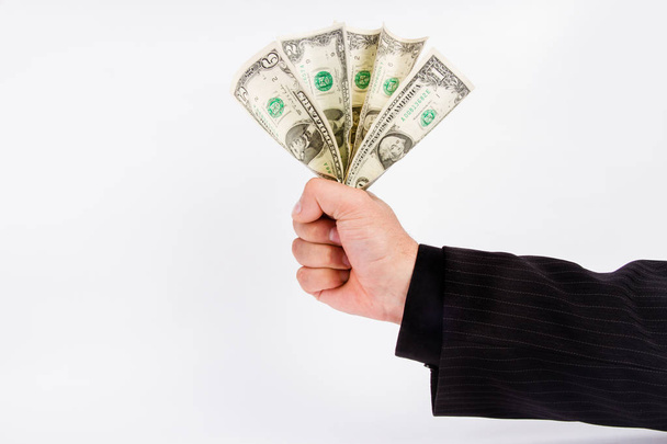 male business hand in a striped suit holds a few dollar bills. - Fotoğraf, Görsel