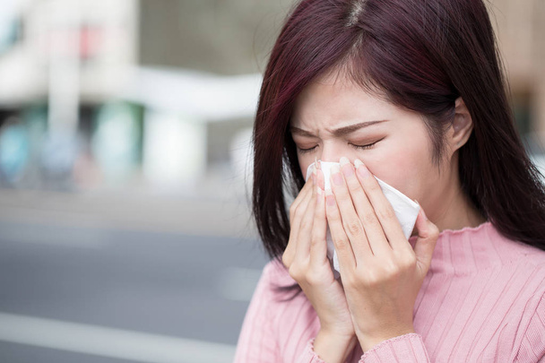 woman feel sneezing and wear mask in the city - Photo, Image