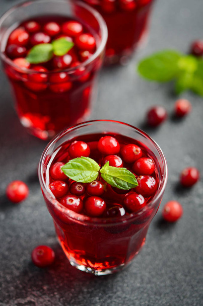 Refreshing cocktail with cranberry and mint on dark concrete background - Foto, Bild