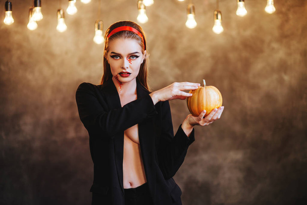 Halloween. Portrait of young beautiful girl with make-up s on her face - Фото, изображение