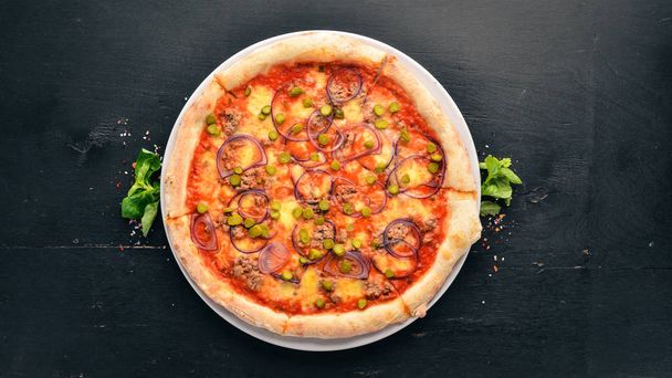 Pizza with tuna and onion. Italian traditional dish. On the old background. Top view. Free space for your text. - Foto, Imagem