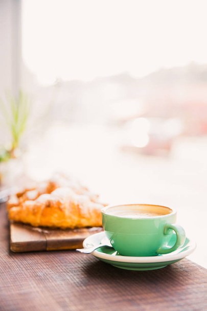 Photo of croissants and cup of coffee on a table in a cafe - 写真・画像