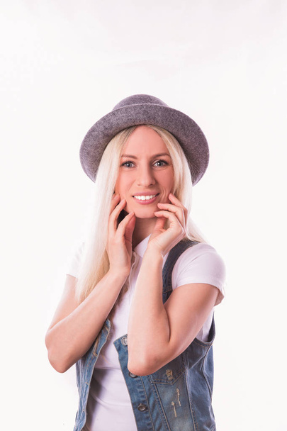 Portrait of young stylish blonde woman in hat against the white background - Fotografie, Obrázek
