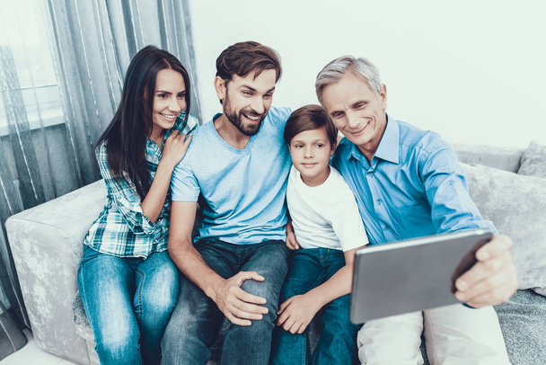 Happy Family Using Tablet PC Together at Home. Using Digital Device. Spending Time Together at Home. Father and Son. Smiling People. Have Fun Indoor. Parenthood Concept. Family at Home. - Photo, Image