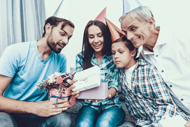 Happy Family Celebrating Mother's Birthday at Home. Smiling People. Have Fun Indoor. Parenthood Concept. Usnhaved Young Man. Family at Home. Happy Family. Giving Gift Boxes. Happy Woman. - Photo, Image