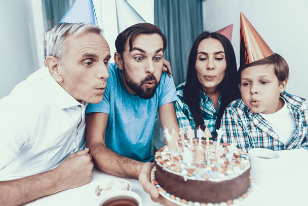 Happy Family Celebrating Father's Birthday at Home. Smiling People. Have Fun Indoor. Parenthood Concept. Usnhaved Young Man. Family at Home. Happy Family. Cake on Birthday. Candles on Cake. - Foto, imagen