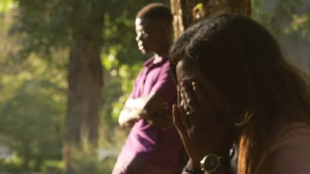 Africký pár po hádancích v parku. Ticho, smutek, pláč - Záběry, video