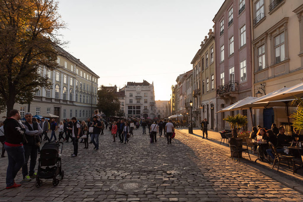 Lviv, Ukraine - Oct 13, 2018: Streets and architecture of the old  Lviv city on a sunny autumn day. Lviv city and Lviv old town with people - Photo, image