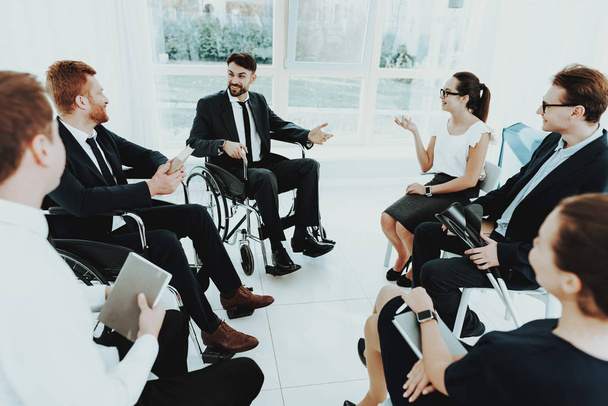 Room with Window. Group Disabled Worker. Workers with Disabilities. People with Limited Opportunities. Business Meeting. Business Suits. Discuss Work Concept. Man in Wheelchair. Meeting Disabled. - Photo, Image