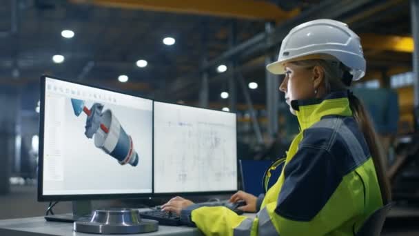 Wewnątrz fabryki przemysłu ciężkiego kobiece inżynier działa na komputerze osobistym na turbiny / silnik projektu w 3d przy użyciu programu Cad. - Materiał filmowy, wideo