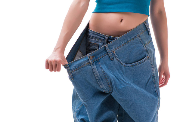 Concept of dieting with oversized jeans - 写真・画像