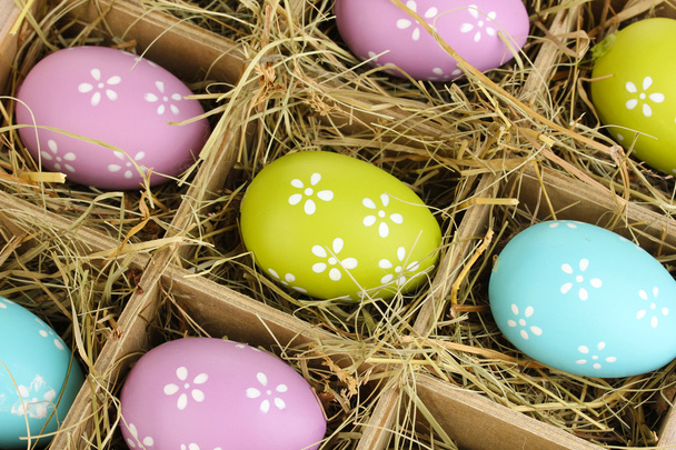 Easter eggs in wooden basket close up - Foto, afbeelding