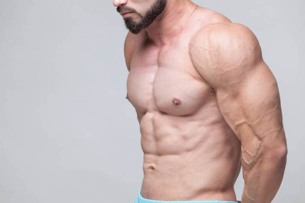 Strong Athletic Man Fitness Model Torso showing six pack abs. isolated on grey background with copyspace - Φωτογραφία, εικόνα